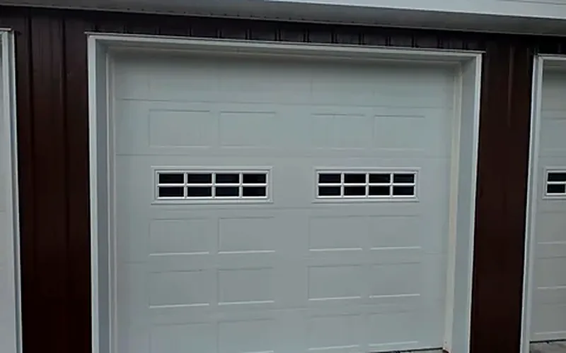 Carriage-style garage door with windows on a pole barn